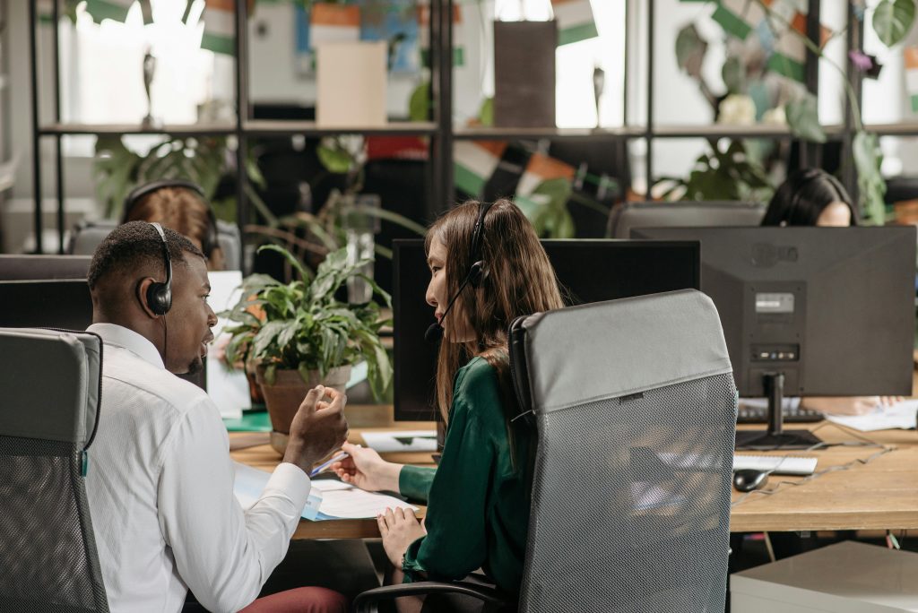 Diverse call center agents collaborating in a modern office environment.